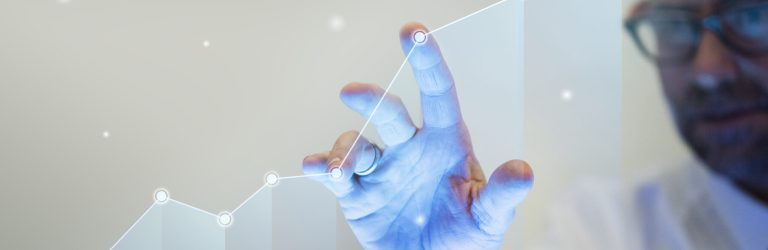 Businessman pointing his finger to a growth graph